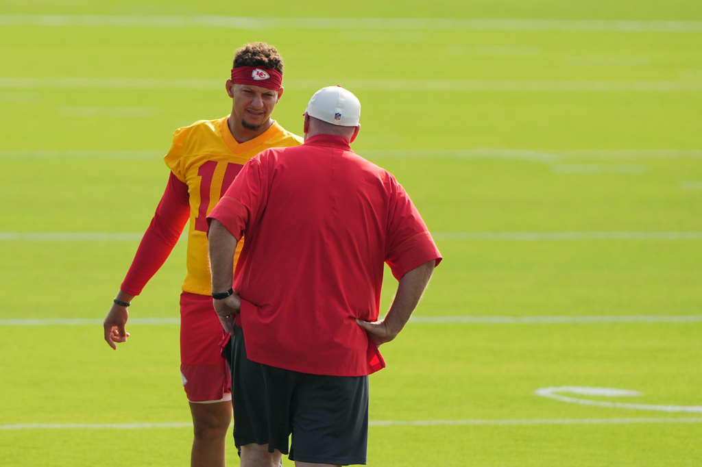 Kansas City Chiefs quarterback Patrick Mahomes talks with head coach Andy Reid at NFL football training camp Saturday, July 25, 2026, in St. Joseph, Mo. (AP Photo/Charlie Riedel)