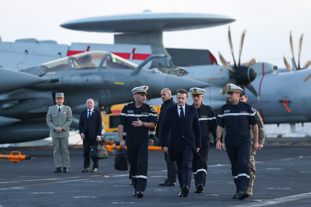 French President Emmanuel Macron, center right, visits the French aircraft carrier Charles de Gaulle, during his visit to Cyprus, Monday March 9, 2026. (Gonzalo Fuentes/Pool Photo via AP)