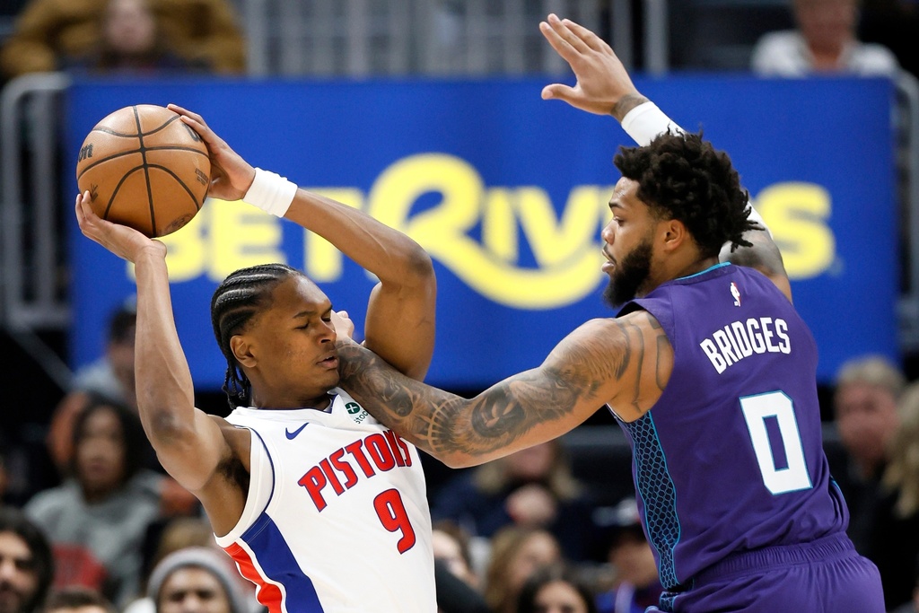 Detroit Pistons guard Ausar Thompson (9) tries going to the basket against Charlotte Hornets forward Miles Bridges (0) during the first half of an NBA basketball game, Saturday, Dec. 20, 2025, in Detroit. (AP Photo/Duane Burleson)