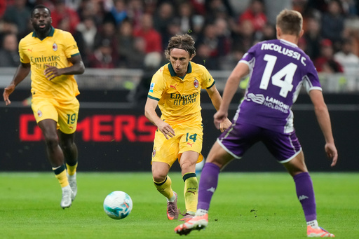 AC Milan's Luka Modric, center, pases the ball past Fiorentina's Hans Nicolussi Caviglia during a Serie A soccer match between AC Milan and Fiorentina in Milan, Italy, Sunday, Oct. 19, 2025. (AP Photo/Luca Bruno) AC Milan's Luka Modric, center, pases the ball past Fiorentina's Hans Nicolussi Caviglia during a Serie A soccer match between AC Milan and Fiorentina in Milan, Italy, Sunday, Oct. 19, 2025. (AP Photo/Luca Bruno)
