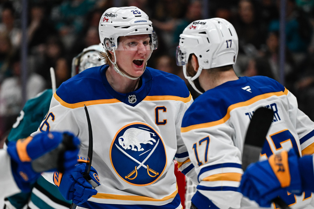Buffalo Sabres defenseman Rasmus Dahlin (26), left, reacts after scoring a goal against the San Jose Sharks during the second period of an NHL hockey game Thursday, March 19, 2026, in San Jose, Calif. (AP Photo/Thien-An Truong)