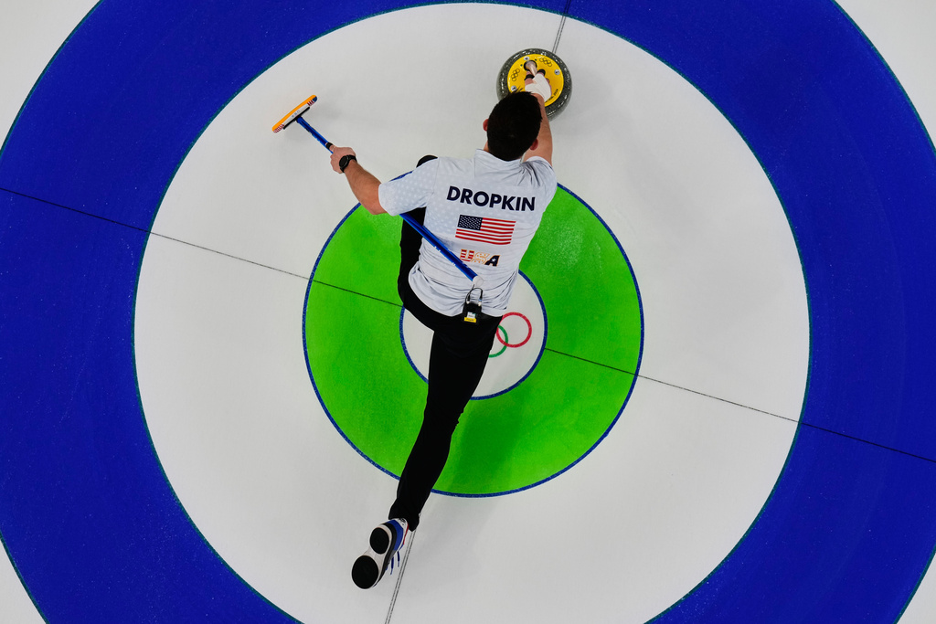Korey Dropkin of the United States competes against Sweden during the curling mix doubles gold medal match at the 2026 Winter Olympics, in Cortina d'Ampezzo, Italy, Tuesday, Feb. 10, 2026. (AP Photo/Bernat Armangue)