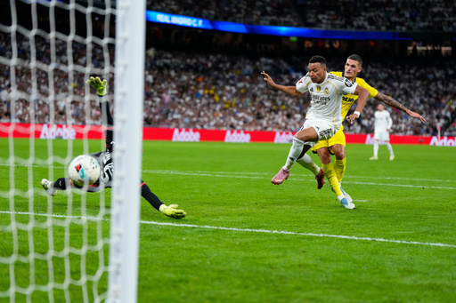 Real Madrid's Kylian Mbappe, centre, scores his side's third goal during the Spanish La Liga soccer match between Real Madrid and Villarreal at the Santiago Bernabeu stadium in Madrid, Spain, Saturday, Oct. 4, 2025. (AP Photo/Manu Fernandez) Real Madrid's Kylian Mbappe, centre, scores his side's third goal during the Spanish La Liga soccer match between Real Madrid and Villarreal at the Santiago Bernabeu stadium in Madrid, Spain, Saturday, Oct. 4, 2025. (AP Photo/Manu Fernandez)