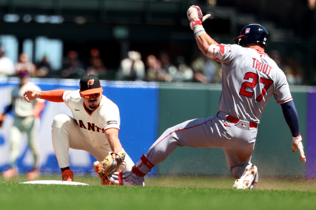 San Francisco Giants shortstop Willy Adames, left, tags out Los Angeles Angels' Mike Trout (27) who was trying to stretch a single into a double during the fifth inning of a baseball game in San Francisco, Sunday, July 26, 2026. (AP Photo/Jed Jacobsohn)