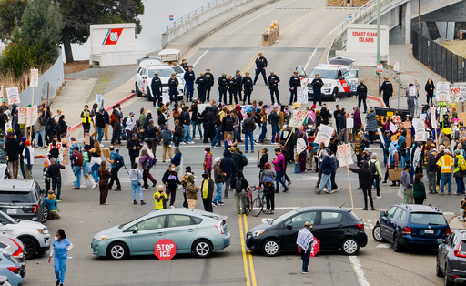 Protesters and vehicles block the entrance to Coast Guard Base Alameda shortly after a caravan of U.S. Customs and Border Protection personnel arrived on Thursday, Oct. 23, 2025, in Oakland, Calif. (AP Photo/Noah Berger) Protesters and vehicles block the entrance to Coast Guard Base Alameda shortly after a caravan of U.S. Customs and Border Protection personnel arrived on Thursday, Oct. 23, 2025, in Oakland, Calif. (AP Photo/Noah Berger)