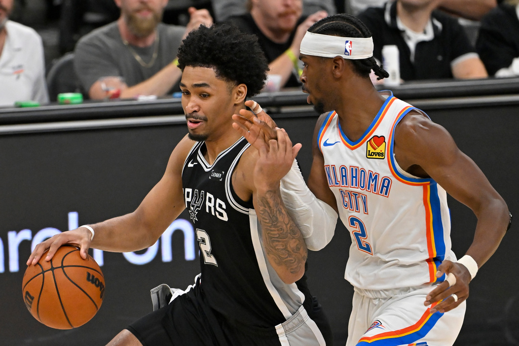 San Antonio Spurs guard Dylan Harper (2) drives against Oklahoma City Thunder guard Shai Gilgeous-Alexander (2) in the second half of Game 6 in the Western Conference finals NBA basketball playoffs series, Thursday, May 28, 2026, in San Antonio. (AP Photo/Darren Abate)