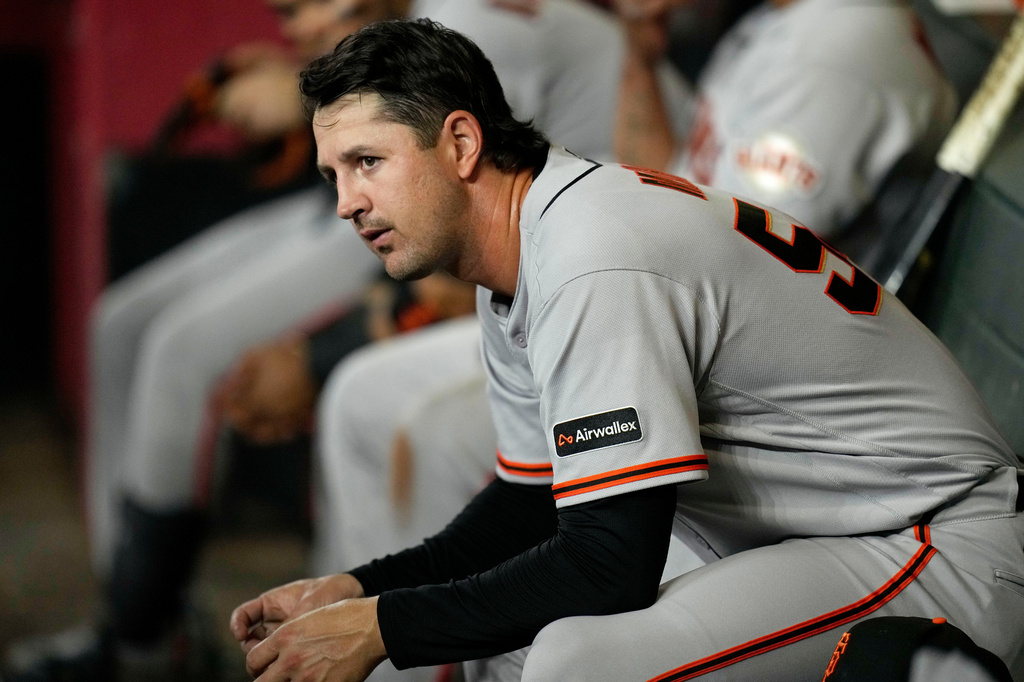 San Francisco Giants starting pitcher Tyler Mahle pauses in the team dugout during the fifth inning of a baseball game against the Arizona Diamondbacks, Wednesday, May 20, 2026, in Phoenix. (AP Photo/Ross D. Franklin)