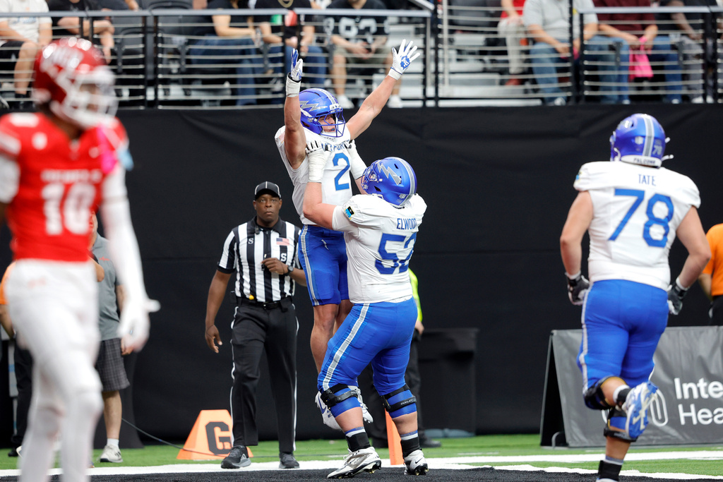 Air Force running back Owen Allen (2) celebrates with offensive lineman Nathan Elwood (52) after scoring a touchdown against UNLV during the first half of an NCAA football game Saturday, Oct. 11, 2025, in Las Vegas. (Steve Marcus/Las Vegas Sun via AP)