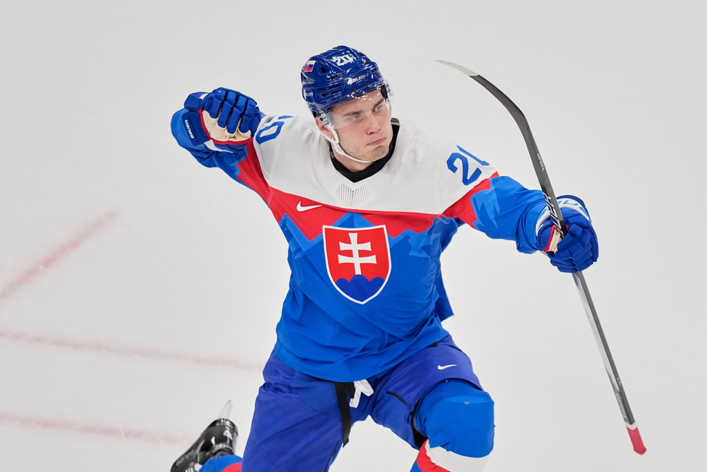 Slovakia's Juraj Slafkovsky celebrates after scoring her side's opening goal during a preliminary round match of men's ice hockey between Slovakia and Finland at the 2026 Winter Olympics, in Milan, Italy, Wednesday, Feb. 11, 2026. (AP Photo/Petr David Josek)