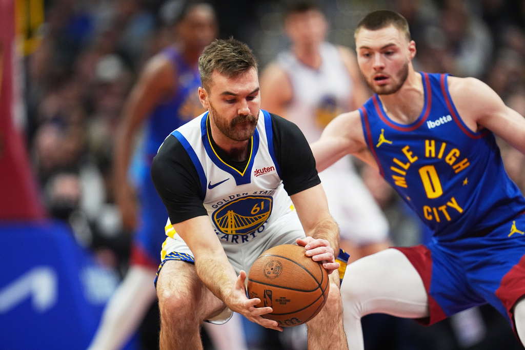 Golden State Warriors guard Pat Spencer, left, recovers the ball as Denver Nuggets guard Christian Braun (0) covers in the first half of an NBA Cup basketball game Friday, Nov. 7, 2025, in Denver. (AP Photo/David Zalubowski)