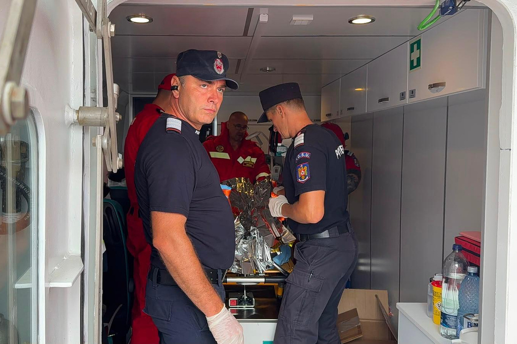 An image released by ISU Tulcea, Romanian Inspectorate for Emergency Situations, shows rescuers and paramedics attending to an injured crew member in Tulcea, Romania, Tuesday, July 21, 2026, after an LPG tanker ship sailing across the Black Sea toward a Ukrainian port caught fire off the coast of Romania last night, an incident Romania's president said was "most likely" related to Russia's war in Ukraine. (ISU Tulcea via AP)