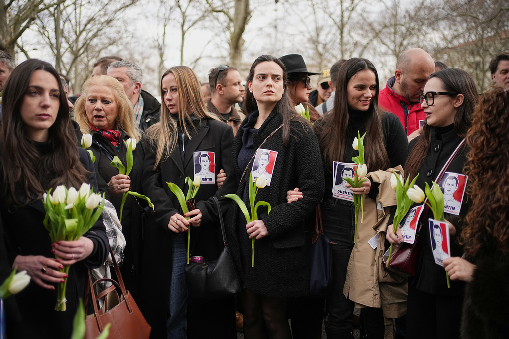 Alice Cordier, third left, French far-right activist president of the identitarian group Collectif Némésis, takes part in a march in Lyon, France, Saturday, Feb. 21, 2026, to pay tribute to Quentin Deranque, a 23-year-old nationalist activist who died from a beating after a clash between far-left and far-right supporters near a student meeting. (AP Photo/Laurent Cipriani)