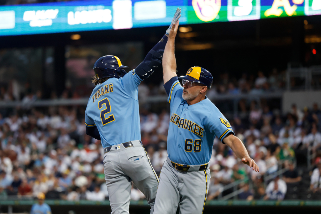 Milwaukee Brewers' Brice Turang (2) is greeted by third base coach Matt Erickson, right, as he rounds the bases after hitting a two-run home run during the third inning of a baseball game against the Athletics, Monday, June 8, 2026, in Las Vegas. (AP Photo/Caroline Brehman)