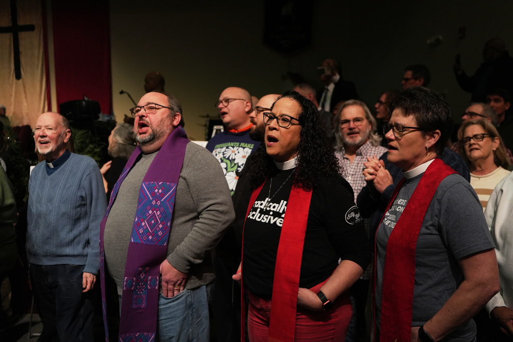 Faith leaders sing together as a sign of support for Haitian migrants fearing the end of their Temporary Protected Status in the U.S., at an event held at St. John Missionary Baptist Church in Springfield, Ohio on Monday, Feb. 2, 2026. (AP Photo/Luis Andres Henao)