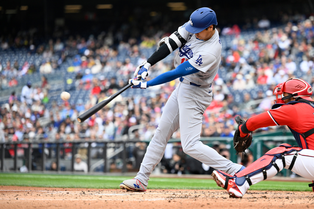Los Angeles Dodgers' Shohei Ohtani hits a home run during the third inning of a baseball game against the Washington Nationals, Sunday, April 5, 2026, in Washington. (AP Photo/Nick Wass)