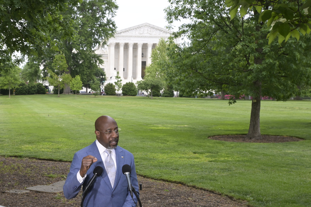 Sen. Raphael Warnock, D-Ga., holds a news conference regarding the Supreme Court Voting Rights decision on Capitol Hill, Wednesday, April 29, 2026, in Washington. (AP Photo/Rod Lamkey Jr.)