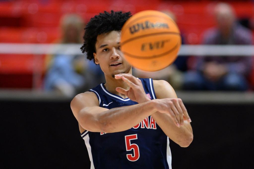 Arizona guard Brayden Burries passes during the second half of an NCAA college basketball game against Utah, Saturday, Jan. 3, 2026, in Salt Lake City. (AP Photo/Tyler Tate)