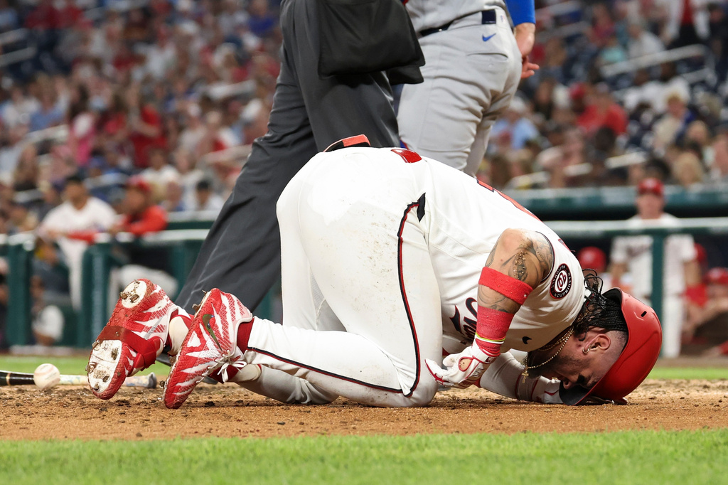 Washington Nationals' Andrés Chaparro goes to the ground after being hit by Chicago Cubs pitcher Shota Imanaga during the fifth inning of a baseball game, Tuesday, Aug 11, 2026, in Washington. (AP Photo/Terrance Williams)