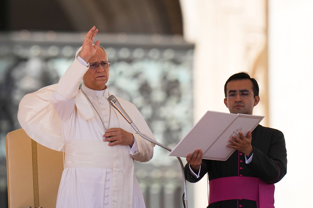 Pope Leo XIV, left, flanked by his private secretary, Edgard Ivan Rimaycuna Inga, delivers his blessing during his weekly general audience in St. Peter's Square, at the Vatican, Wednesday, Sept. 23, 2026. (AP Photo/Alessandra Tarantino)