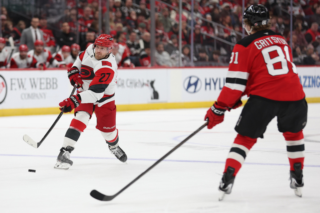 Carolina Hurricanes left wing Nikolaj Ehlers (27) takes a shot in the first period of an NHL hockey game against the New Jersey Devils, Sunday, Jan. 4, 2026, in Newark, N.J. (AP Photo/Heather Khalifa)