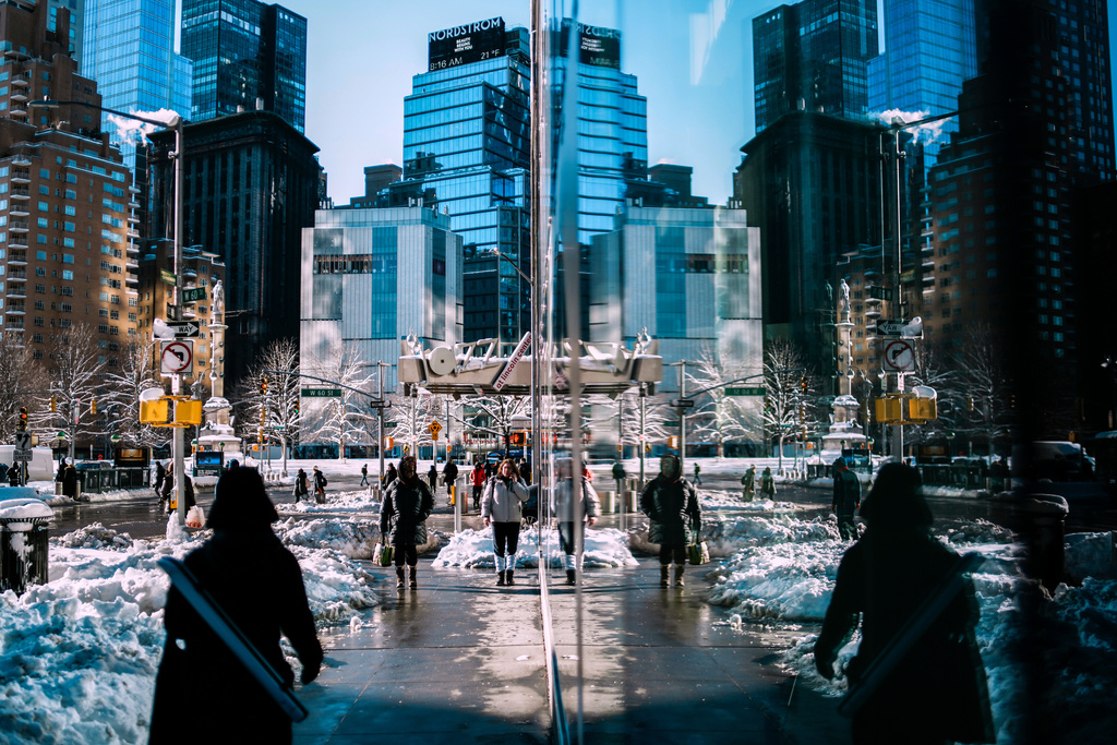 People make their way near piles of plowed snow a day after a winter storm on Tuesday, Feb. 24, 2026, in New York. (AP Photo/Eduardo Munoz Alvarez)