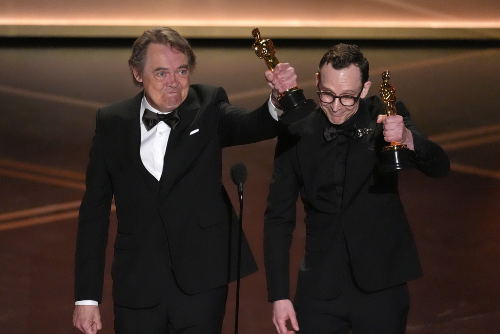 Maciek Szczerbowski, left, and Chris Lavis accept the award for animated short film for "The Girl Who Cried Pearls" during the Oscars on Sunday, March 15, 2026, at the Dolby Theatre in Los Angeles. (AP Photo/Chris Pizzello)