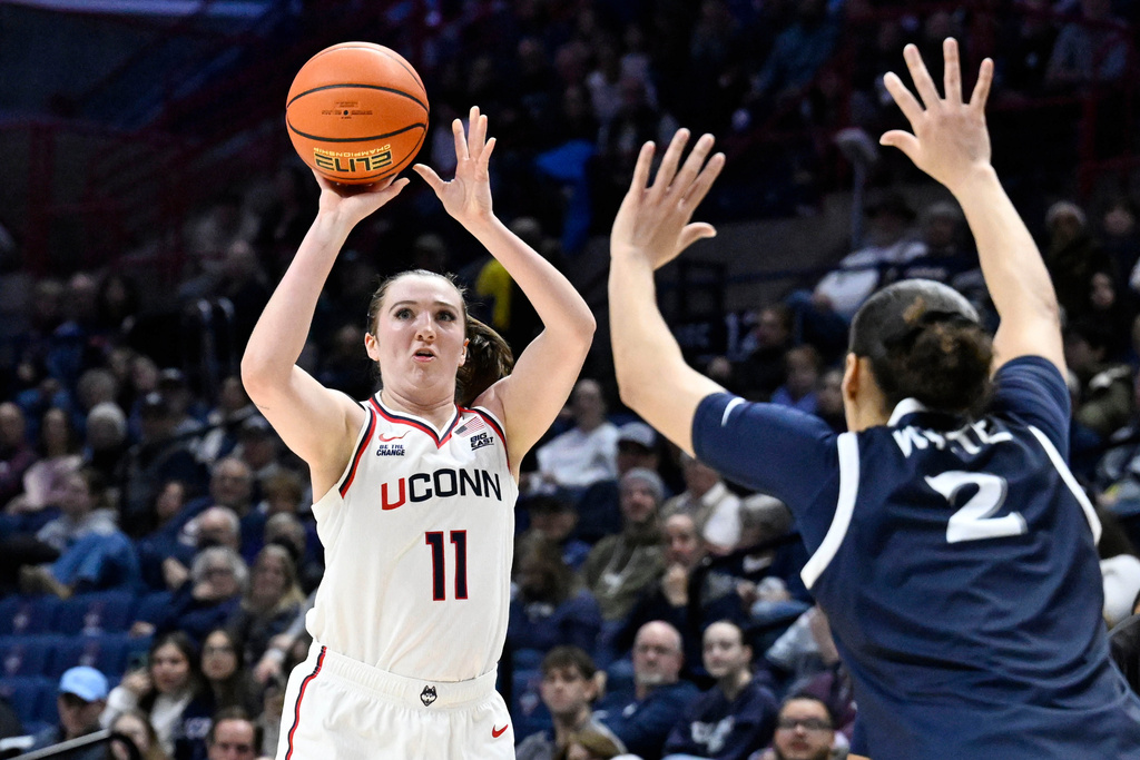 UConn guard Allie Ziebell (11) shoots as Xavier guard Savannah White (2) defends in the first half of an NCAA college basketball game, Wednesday, Jan. 28, 2026, in Storrs, Conn. (AP Photo/Jessica Hill)