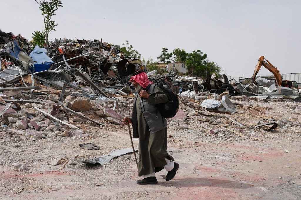 A man inspects the site of an Israeli army demolition campaign that targeted several Palestinian commercial structures overnight, days after the issue of demolition and evacuation orders to owners, in the West Bank town of Al-Eizariya Tuesday, May 12, 2026. (AP Photo/Mahmoud Illean)