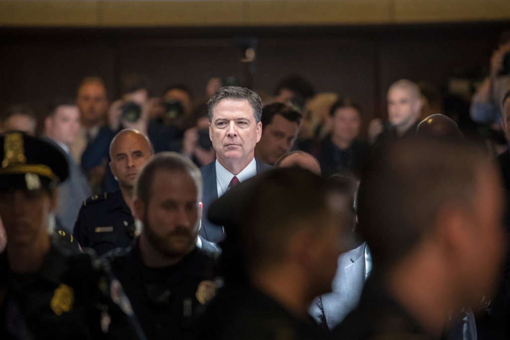 FILE - Former FBI director James Comey walks through a corridor on the way to a secure room to continue his testimony to the Senate Select Committee on Intelligence, on Capitol Hill in Washington, June 8, 2017. (AP Photo/J. Scott Applewhite, File)