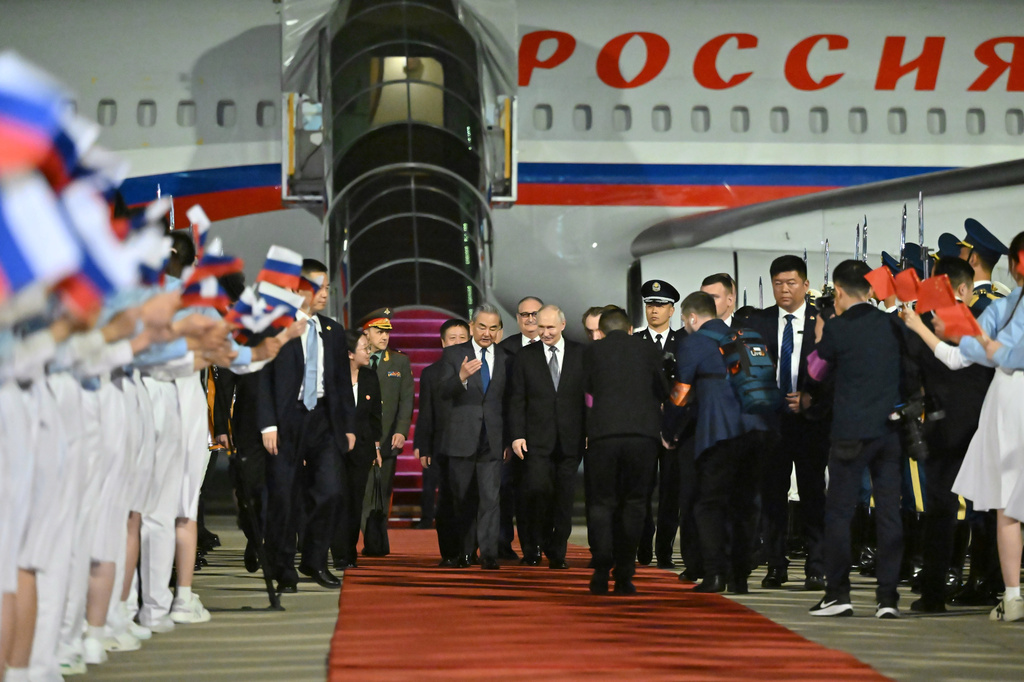 In this photo released by Xinhua News Agency, Russian President Vladimir Putin, center right walks with Chinese Foreign Minister Wang Yi upon arrival for a state visit in Beijing on Tuesday, May 19, 2026. (Gao Jie/Xinhua via AP)