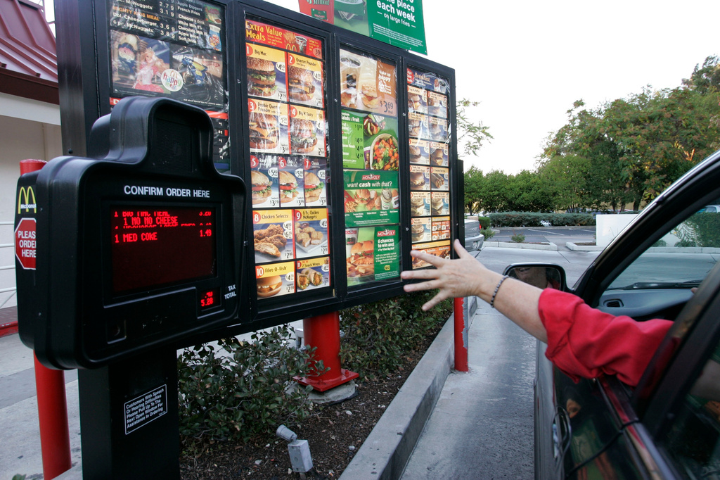 FILE - A customer orders a meal at a drive-thru at McDonald's restaurant in Palo Alto, Calif., Wednesday, Oct. 18, 2006. (AP Photo/Paul Sakuma, File)