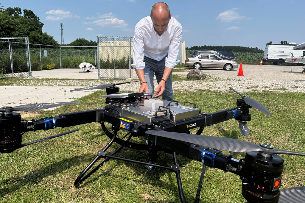 Volatus Aerospace COO Greg Colacitti inspects a heavy lift drone before a test run on July 13, 2026, in Kleinburg, Ontario. (AP Photo/Kelvin Chan)