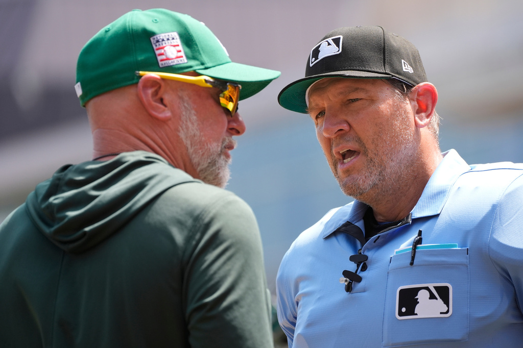 Home plate umpire Chad Fairchild, right, explains to Athletics manager Mark Kotsay why he threw out coach Chris Cron after an argument over a balk call in the second inning of a baseball game against the Minnesota Twins, Sunday, July 26, 2026, in Minneapolis. (AP Photo/Bruce Kluckhohn)