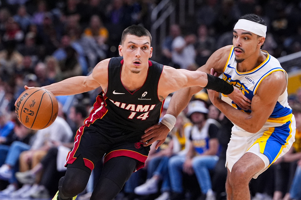 Miami Heat guard Tyler Herro (14) holds off Indiana Pacers guard Andrew Nembhard (2) during the second half of an NBA basketball game in Indianapolis, Sunday, March 29, 2026. (AP Photo/Michael Conroy)