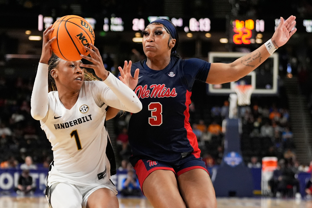 Vanderbilt guard Mikayla Blakes drives to the basket past Mississippi guard Kaitlin Peterson during second half of an NCAA college basketball game in the quarterfinals of the Southeastern Conference tournament, Friday, March 6, 2026, in Greenville, S.C. (AP Photo/Chris Carlson)