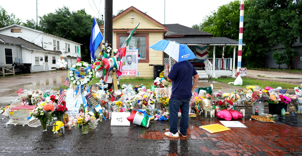 Sergio Lira views a growing memorial at the site where Lorenzo Salgado Araujo was fatally shot by ICE agents, last week, is seen on Monday, July 13, 2026, in Houston. (AP Photo/Karen Warren)
