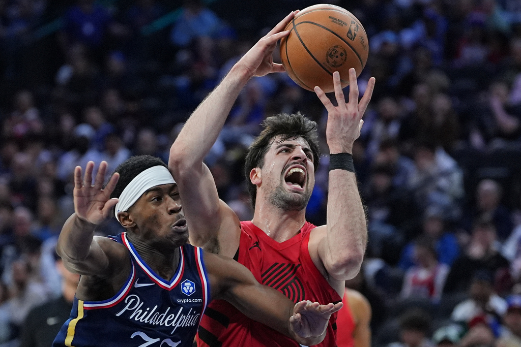 Portland Trail Blazers' Deni Avdija, right, goes up to shoot against Philadelphia 76ers' Vj Edgecombe during the first half of an NBA basketball game Sunday, March 15, 2026, in Philadelphia. (AP Photo/Matt Rourke)