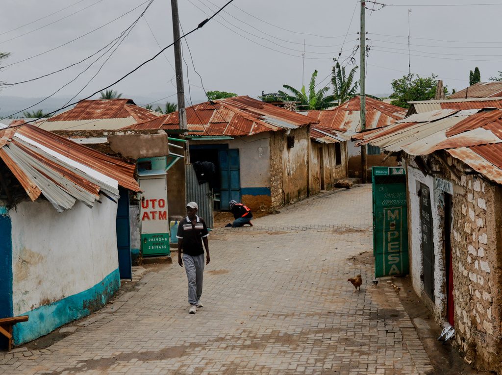 A man walks along an alley in Owino Uhuru village, an informal settlement in Mikindani, Mombasa County, Kenya, on April 10, 2026. (AP Photo/Kelvin Rading)