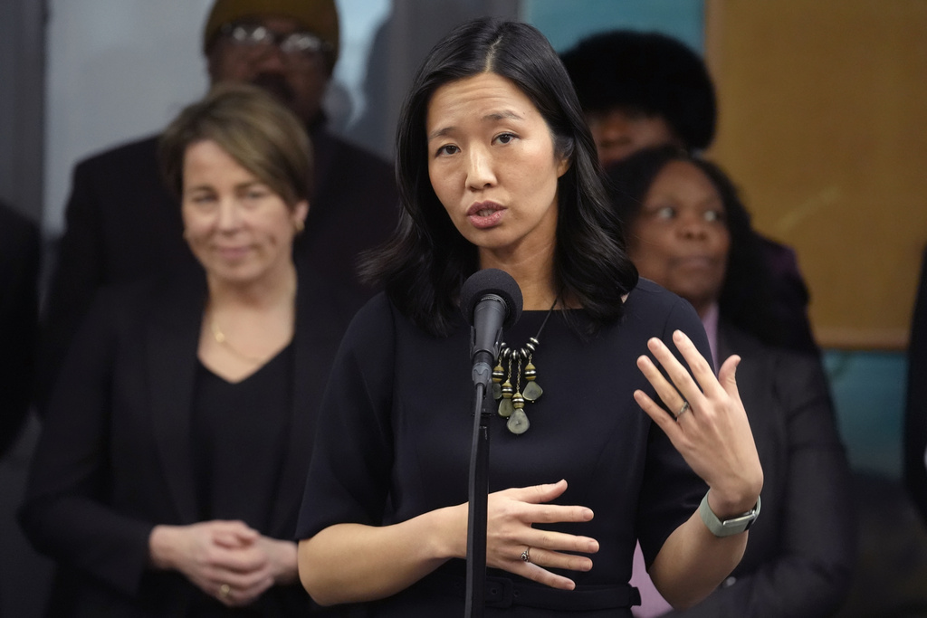 FILE - Boston Mayor Michelle Wu, center, and Massachusetts Gov. Maura Healey, left, take questions from reporters Jan. 31, 2024, after touring the Cass Recreational Complex, in the Roxbury neighborhood of Boston. (AP Photo/Steven Senne, File)