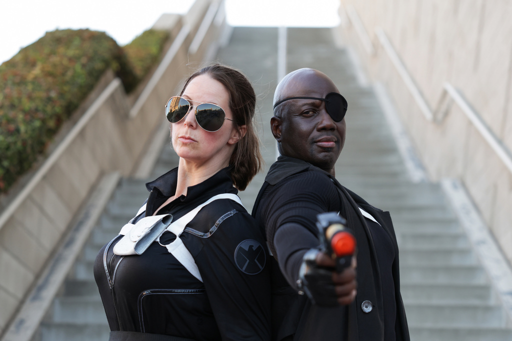 Rebecca Eusey of San Diego, left, dressed as an agent of S.H.I.E.L.D., and Jamald Acey of New York dressed as Nick Fury pose for a photograph during preview night of Comic-Con International on Wednesday, July 22, 2026, in San Diego. (Photo by Andrew Park/Invision/AP)