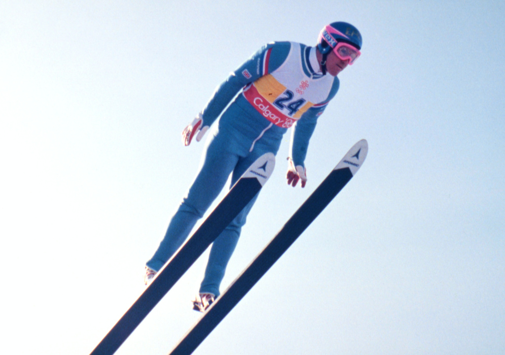FILE - British ski jumper Michael Edwards known as Eddie The Eagle flies towards 58th, and last place, in the 70 meter ski jump at the Winter Olympics, in Calgary, February 14, 1988. (AP Photo/Katsumi Kasahara, File)