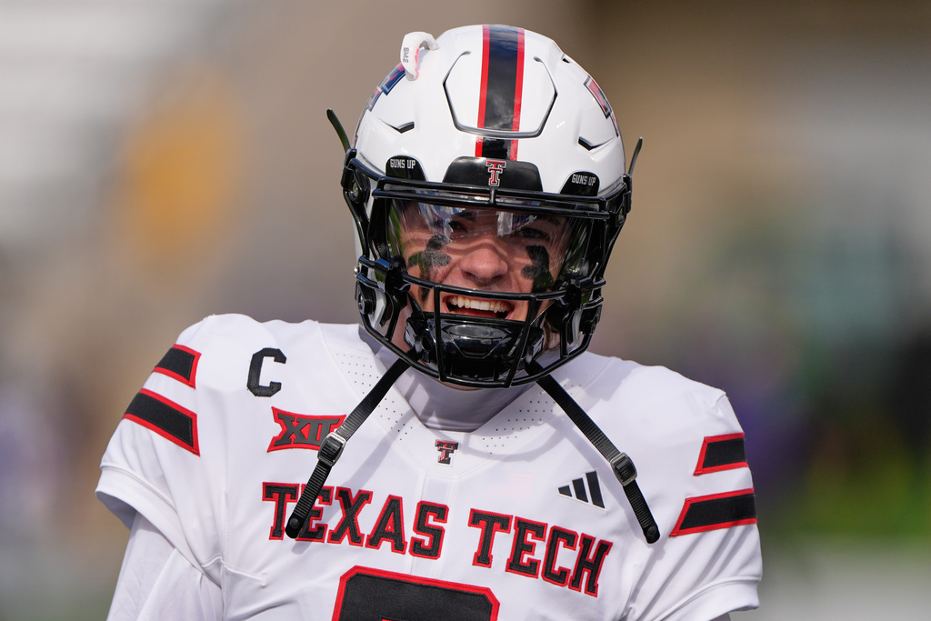 Texas Tech quarterback Behren Morton talks to teammates before an NCAA college football game against Kansas State, Saturday, Nov. 1, 2025, in Manhattan, Kan. (AP Photo/Charlie Riedel)