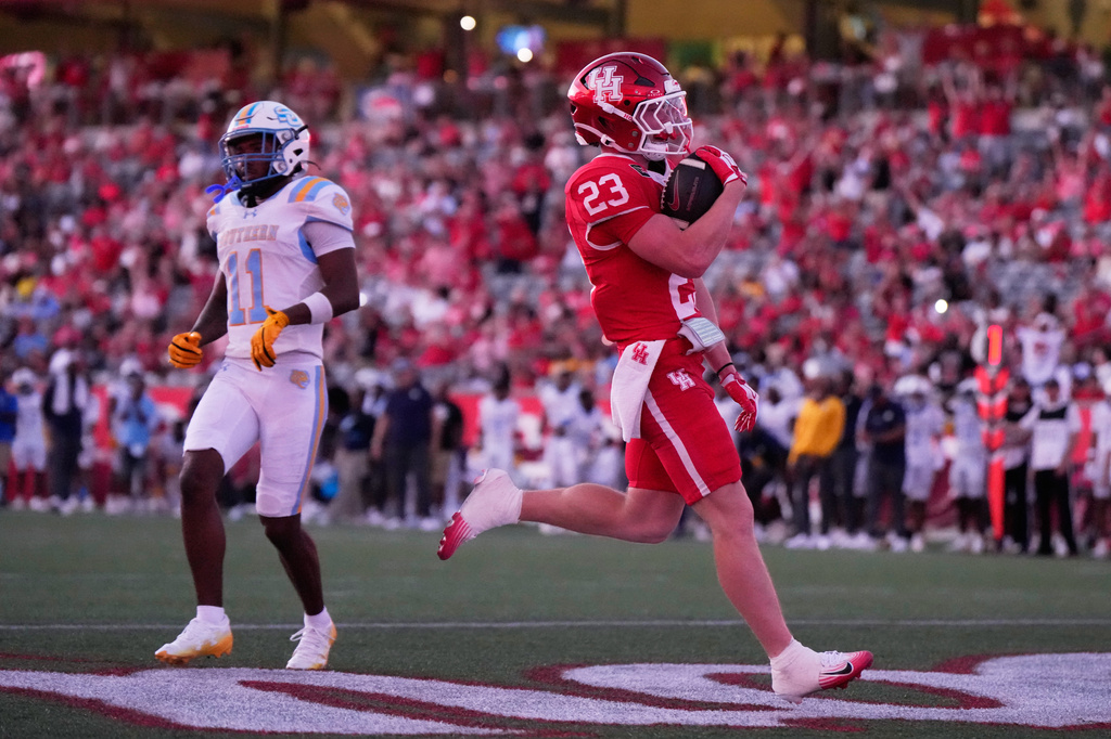 Houston running back John Hebert (23) runs to the end zone for a touchdown during the first half of an NCAA college football game against Southern in Houston, Saturday, Sept. 12, 2026. (AP Photo/Ashley Landis)