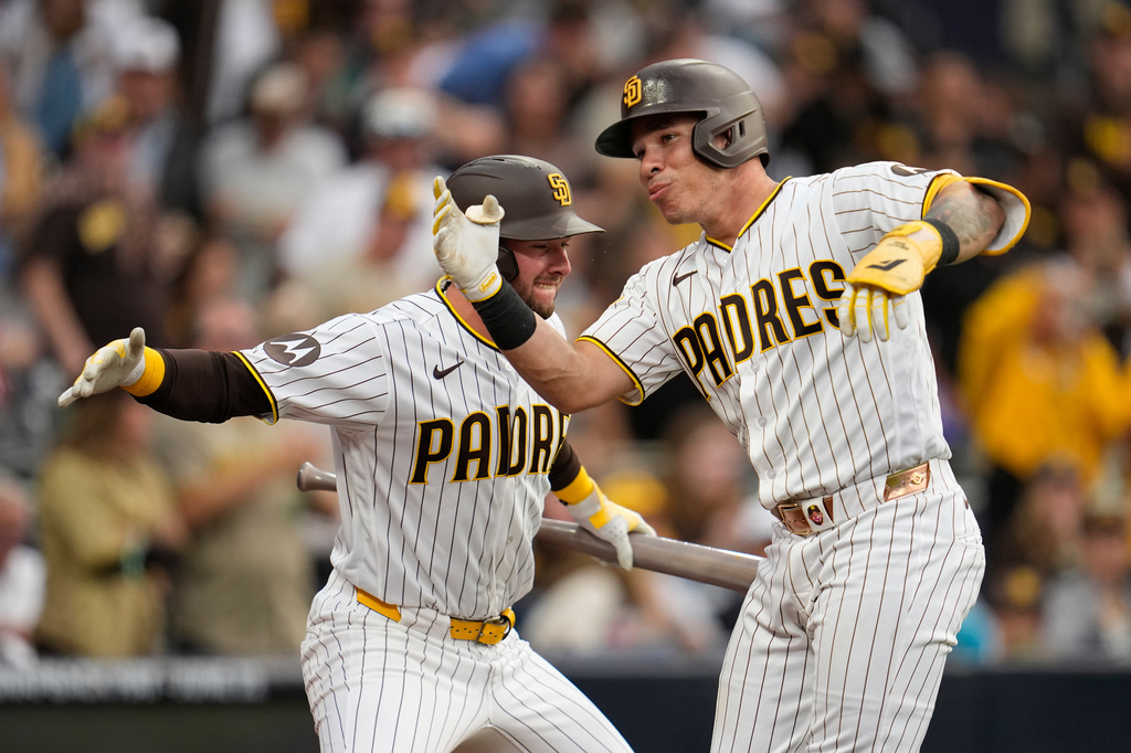 San Diego Padres' Freddy Fermin, right, celebrates with teammate Jackson Merrill after hitting a home run during the third inning of a baseball game against the Cincinnati Reds Monday, June 8, 2026, in San Diego. (AP Photo/Gregory Bull)