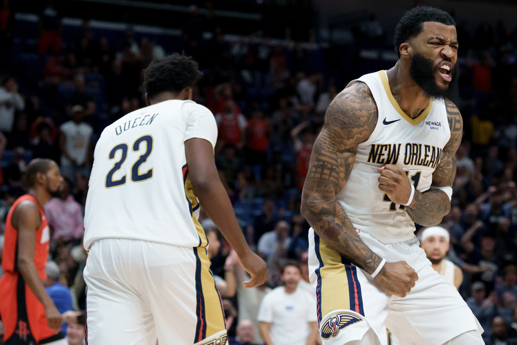 New Orleans Pelicans guard Saddiq Bey, right, reacts after dunking against the Houston Rockets during the second half of an NBA basketball game in New Orleans, Thursday, Dec. 18, 2025. (AP Photo/Matthew Hinton)