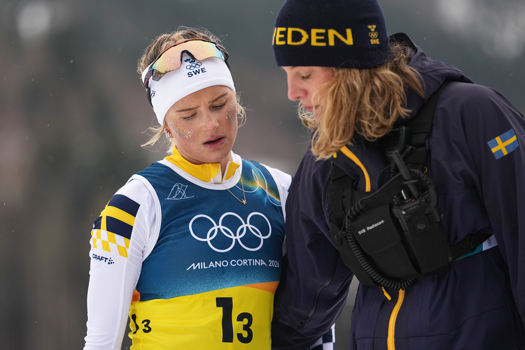Frida Karlsson, of Sweden, walks off the course after completing her leg of the cross country skiing women's 4 x 7.5km relay at the 2026 Winter Olympics, in Tesero, Italy, Saturday, Feb. 14, 2026. (AP Photo/Matthias Schrader)