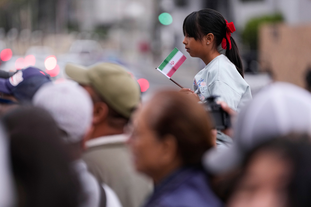 Fans wait to greet members of the Iran World Cup soccer team as they leave their hotel for the airport Tuesday, June 30, 2026, in Tijuana, Mexico. (AP Photo/Gregory Bull)