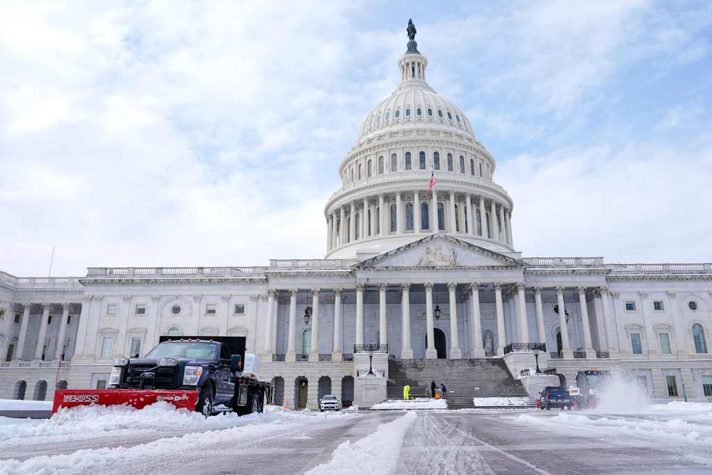 Workers clear the Capitol grounds after a snowstorm Monday, Jan. 26, 2026, in Washington. (AP Photo/Mariam Zuhaib)