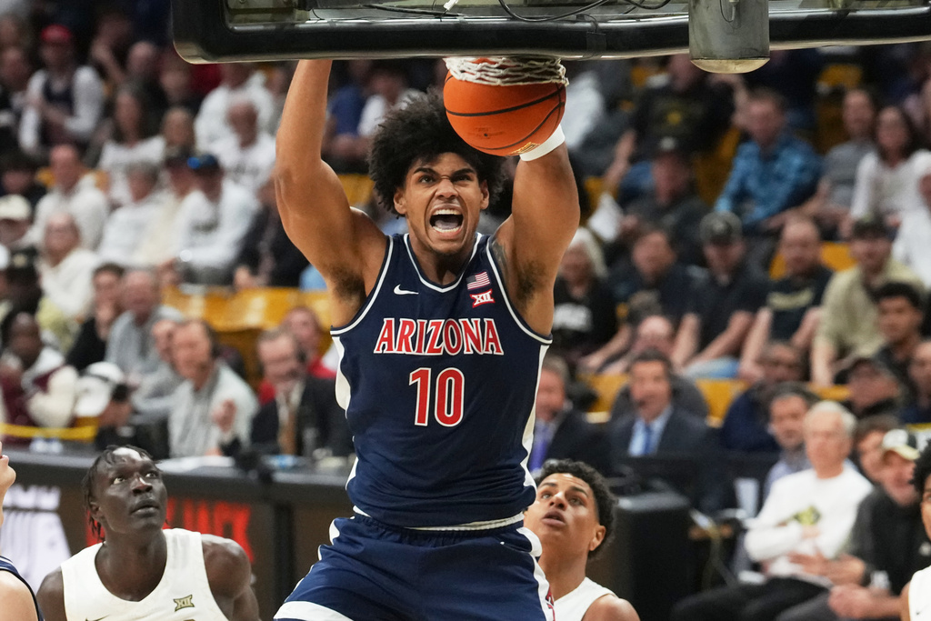 Arizona forward Koa Peat reacts as he dunks the ball for a basket against Colorado in the first half of an NCAA college basketball game Saturday, March 7, 2026, in Boulder, Colo. (AP Photo/David Zalubowski)