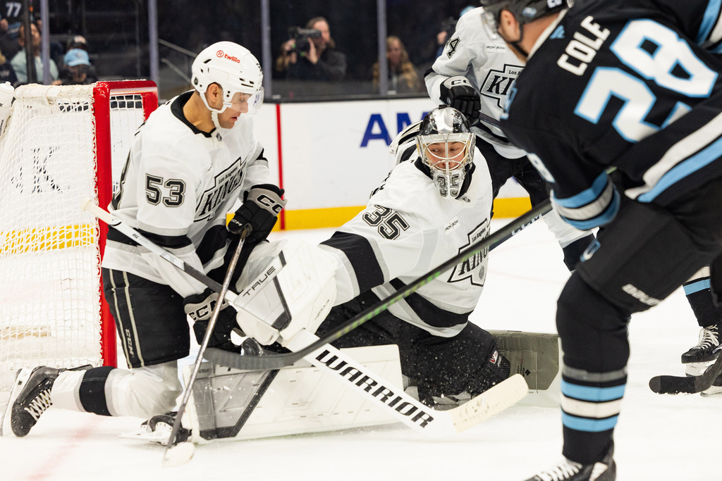 Los Angeles Kings goalie Darcy Kuemper (35) and right wing Jared Wright (53) blocks the puck against Utah Mammoth defenseman Ian Cole (28) during the first period of an NHL hockey game, Sunday, March 22, 2026, in Salt Lake City. (AP Photo/Melissa Majchrzak)
